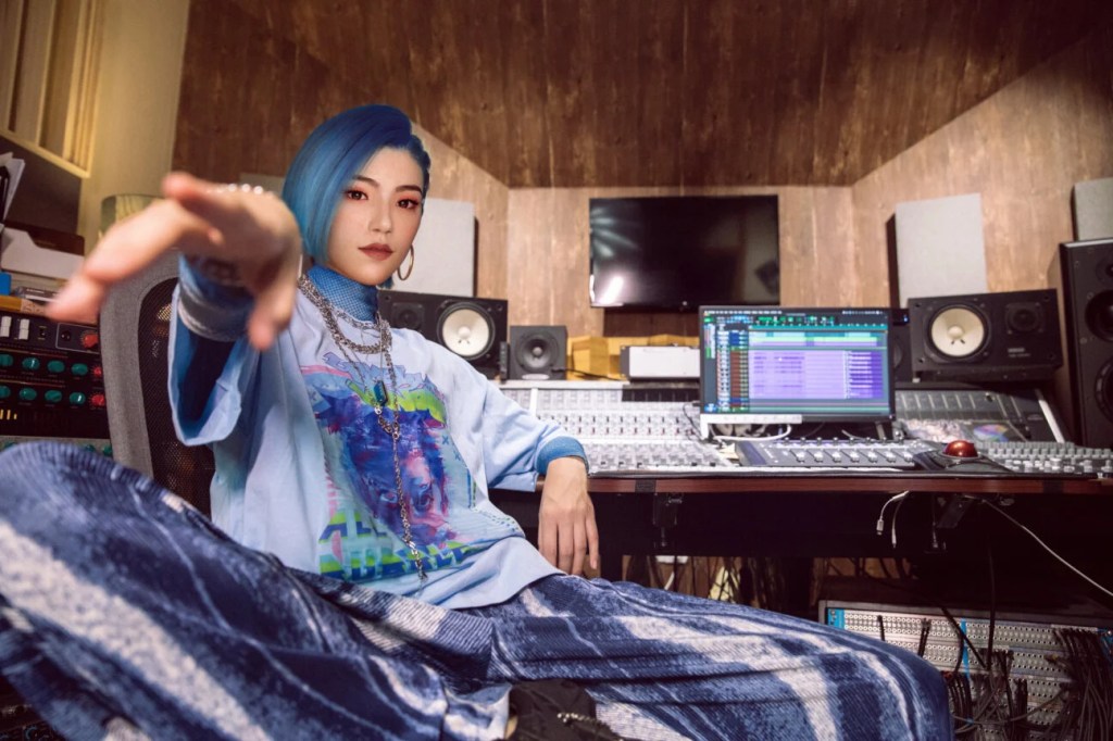Virtual ops star Hi Jiang sitting in a recording studio. 